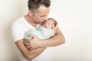 Vater hält Baby auf dem Arm